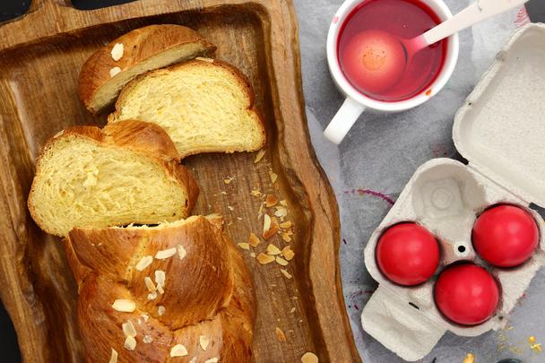 Easter sweet brioche, red eggs and liquid dye